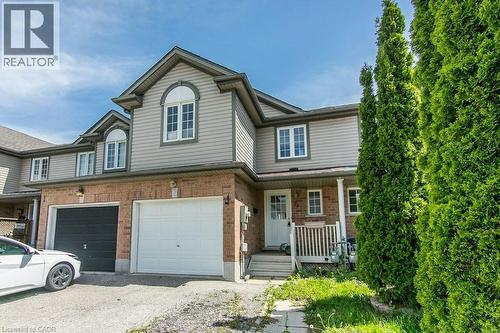 Two-story townhome featuring a brick and siding exterior with a pitched roof - 71 Foxglove Crescent, Kitchener, ON - Outdoor
