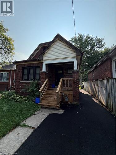Brick exterior with white siding gable accent - 21 Haddon Avenue S, Hamilton, ON - Outdoor