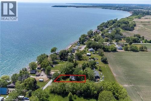 Aerial perspective showcasing a property with waterfront access, surrounded by mature trees - 28 Derner Line, Lowbanks, ON - Outdoor With Body Of Water With View