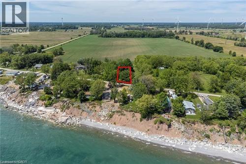 Elevated waterfront parcel featuring mature trees, a rocky shoreline, and expansive agricultural fields - 28 Derner Line, Lowbanks, ON - Outdoor With Body Of Water With View