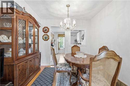 Dining area featuring wood-finish flooring and a crystal chandelier - 1526 Westminster Place, Burlington, ON - Indoor Photo Showing Dining Room