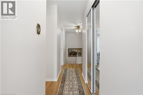 Hallway featuring wood-finish flooring, white baseboards, and a ceiling fan with integrated lighting - 1526 Westminster Place, Burlington, ON - Indoor Photo Showing Other Room