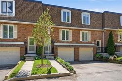 Brick townhouse exterior with a mansard roof - 