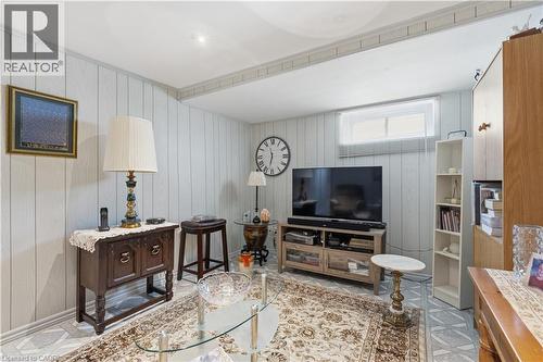 Finished lower level room featuring white vertical plank paneling, a single window with blinds, recessed ceiling lighting, and light-toned patterned flooring - 1526 Westminster Place, Burlington, ON - Indoor