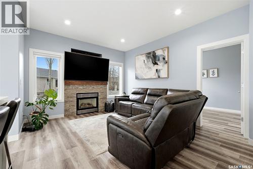 709 Aspen Crescent, Pilot Butte, SK - Indoor Photo Showing Living Room With Fireplace