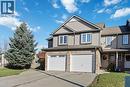 End-unit townhome featuring a two-car garage, gray siding, and brick facade accents - 27 Red Clover Crescent, Kitchener, ON  - Outdoor With Facade 