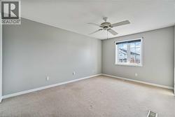 Bright room featuring neutral-toned walls and carpeting - 