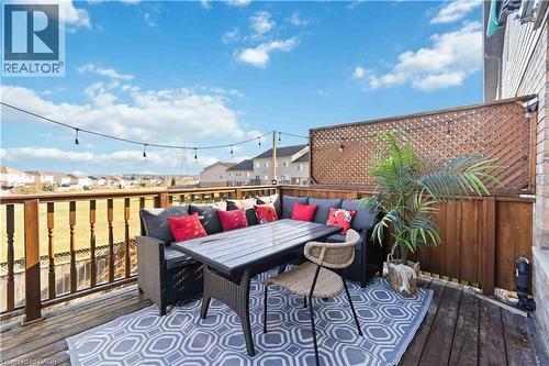 Expansive outdoor deck featuring wood-finish flooring, a full-height wood lattice privacy screen, and an open-air railing - 27 Red Clover Crescent, Kitchener, ON - Outdoor With Deck Patio Veranda