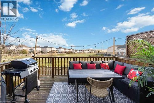 Expansive wood deck with a full-height wood railing, string lighting, and a diagonal lattice privacy screen - 27 Red Clover Crescent, Kitchener, ON - Outdoor With Deck Patio Veranda