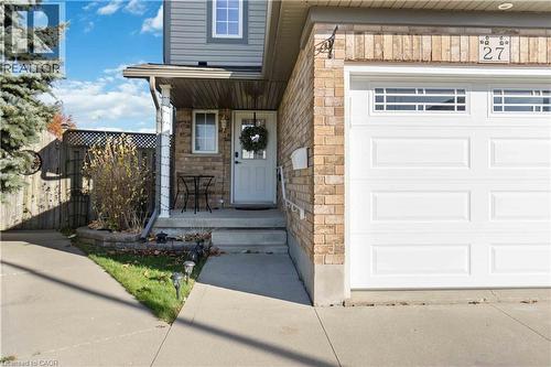 Brick and siding exterior featuring an attached garage with decorative window panels - 27 Red Clover Crescent, Kitchener, ON - Outdoor