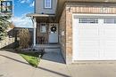 Brick and siding exterior featuring an attached garage with decorative window panels - 27 Red Clover Crescent, Kitchener, ON  - Outdoor 