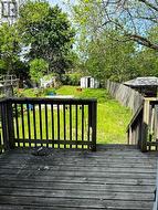 Rear wooden deck with a slatted railing and steps - 
