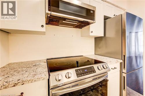 Slim microwave and stainless appliances are included - 1414 King Street E Unit# 101, Kitchener, ON - Indoor Photo Showing Kitchen