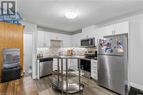 Unit A - Kitchen with tile backsplash & under counter lighting - 158 Laurentian Drive N, London, ON - Indoor Photo Showing Kitchen