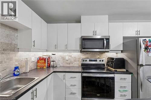 Unit A - Kitchen with tile backsplash & under counter lighting - 158 Laurentian Drive N, London, ON - Indoor Photo Showing Kitchen