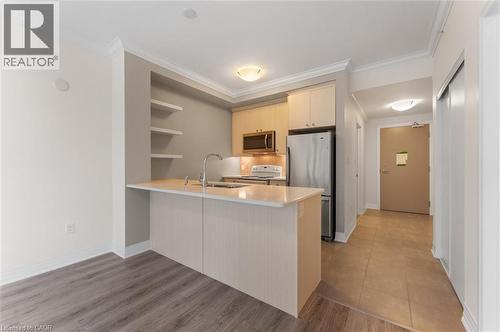 10 Concord Place Unit# 213, Grimsby, ON - Indoor Photo Showing Kitchen With Double Sink