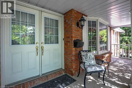 Front porch entry featuring double doors with upper window panes and brass hardware - 81 Reding Road, Ancaster, ON - Outdoor With Deck Patio Veranda With Exterior