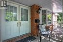 Front porch entry featuring double doors with upper window panes and brass hardware - 81 Reding Road, Ancaster, ON  - Outdoor With Deck Patio Veranda With Exterior 
