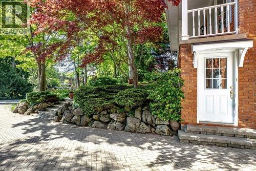 Brick exterior with a white paneled door featuring multiple lites and a gold-tone hardware - 81 Reding Road, Ancaster, ON - Outdoor
