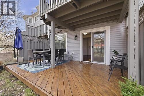 Exterior wooden deck featuring a sliding glass door entry, grey horizontal siding, and a privacy fence with lattice detail - 245 Bishop Street S Unit# 31, Cambridge, ON - Outdoor With Deck Patio Veranda With Exterior