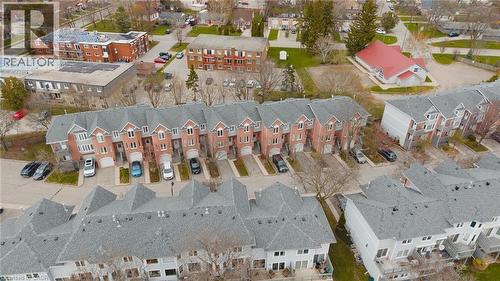 Townhome community featuring brick and siding exteriors, individual garages, and private driveways - 245 Bishop Street S Unit# 31, Cambridge, ON - Outdoor With View