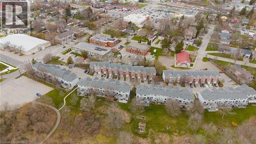 Aerial perspective showcasing a complex of multi-unit residential buildings with varied architectural styles and gray sloped roofs - 245 Bishop Street S Unit# 31, Cambridge, ON - Outdoor With View