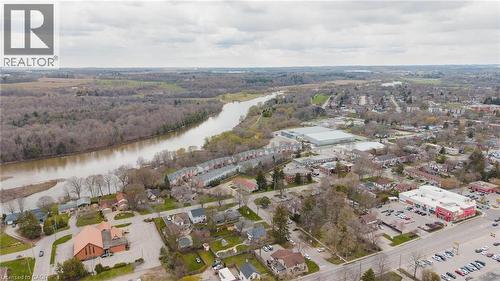 Aerial perspective showcasing a river, extensive tree coverage, and a cluster of townhomes - 245 Bishop Street S Unit# 31, Cambridge, ON - Outdoor With View