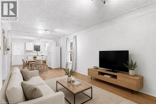 Open-concept living space, virtually staged - 46 East 16Th Street, Hamilton, ON - Indoor Photo Showing Living Room
