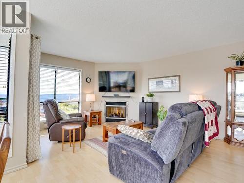 8-3818 Joyce Ave, Powell River, BC - Indoor Photo Showing Living Room With Fireplace