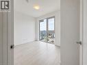 Bright room featuring a large window, light wood-finish flooring, white walls, and a ceiling-mounted light fixture - 75 James Street S Unit# 2614, Hamilton, ON  - Indoor Photo Showing Other Room 