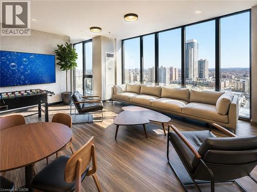 Expansive floor-to-ceiling windows featuring city architecture - 75 James Street S Unit# 2614, Hamilton, ON - Indoor Photo Showing Living Room