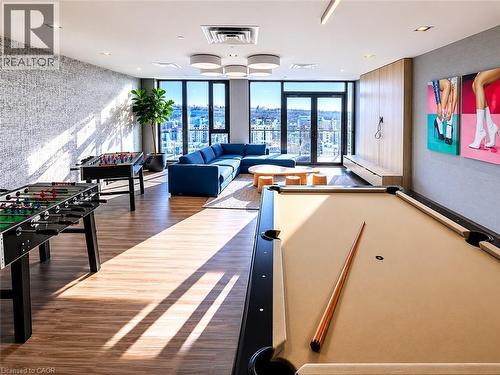 Spacious recreational room featuring wood-finish flooring and large windows - 75 James Street S Unit# 2614, Hamilton, ON - Indoor Photo Showing Other Room