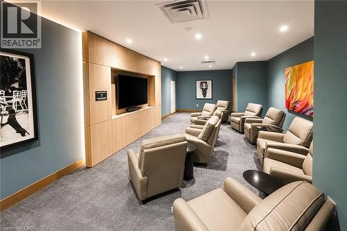 Dedicated media room featuring a large television display within a light wood-finish media console - 75 James Street S Unit# 2614, Hamilton, ON - Indoor Photo Showing Other Room