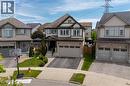 Contemporary two-story residence featuring a brick and siding exterior, an integrated two-car garage, and a covered front entry - 916 Steepleridge Court, Kitchener, ON  - Outdoor With Facade 
