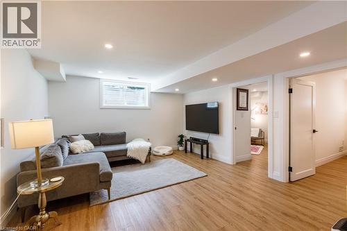 Recreation room featuring wood-finish flooring, recessed lighting, and a window with blinds - 916 Steepleridge Court, Kitchener, ON - Indoor