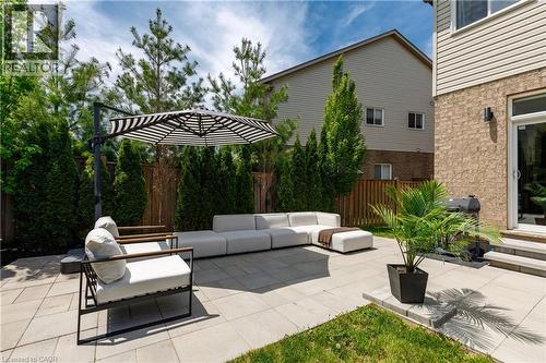 Expansive paver patio with a combination of brick and siding exterior - 916 Steepleridge Court, Kitchener, ON - Outdoor With Exterior