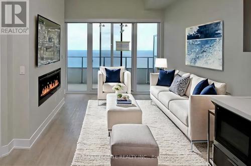 6206 - 30 Shore Breeze Drive, Toronto, ON - Indoor Photo Showing Living Room With Fireplace