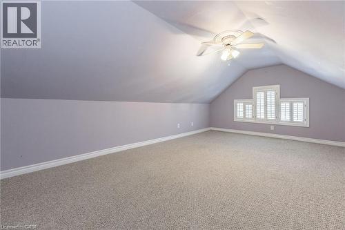 Spacious attic room featuring sloped ceilings, light-toned carpeting, and a ceiling fan with integrated lighting - 252 Beechwood Avenue, Hamilton, ON - Indoor Photo Showing Other Room