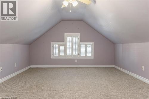 Room featuring sloped ceilings, neutral carpet flooring, and white baseboards - 252 Beechwood Avenue, Hamilton, ON - Indoor Photo Showing Other Room