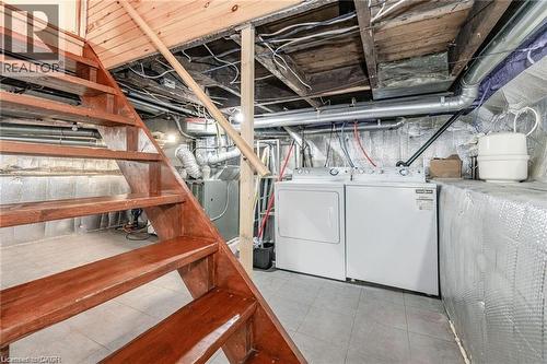 Wood-finish staircase with open risers and a wood handrail - 252 Beechwood Avenue, Hamilton, ON - Indoor Photo Showing Laundry Room