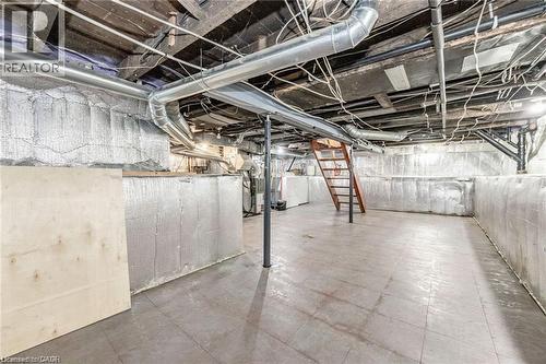 Basement featuring exposed ceiling joists, overhead ductwork, and a wooden staircase - 252 Beechwood Avenue, Hamilton, ON - Indoor Photo Showing Basement