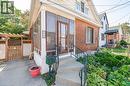 Brick and siding exterior with a screened-in porch, concrete steps, and a wrought iron handrail - 252 Beechwood Avenue, Hamilton, ON  - Outdoor With Exterior 