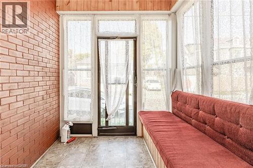Enclosed sunroom featuring a brick wall, wood-paneled ceiling, and light-toned floor tile - 252 Beechwood Avenue, Hamilton, ON - Indoor Photo Showing Other Room