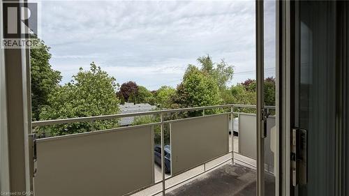 Private balcony featuring metal railings and opaque panels, with a natural green backdrop - 206 Indian Road, Kitchener, ON - Outdoor With Exterior