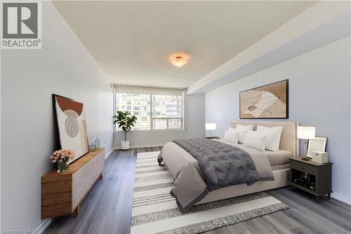 Spacious interior featuring wood-finish flooring and a large window - 1270 Maple Crossing Boulevard Unit# 1705, Burlington, ON - Indoor Photo Showing Bedroom