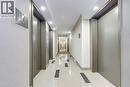 Brightly lit hallway featuring recessed lighting and wall sconces, contemporary textured wall finishes, and polished tile flooring with dark accent inlays - 1270 Maple Crossing Boulevard Unit# 1705, Burlington, ON  - Indoor Photo Showing Other Room 
