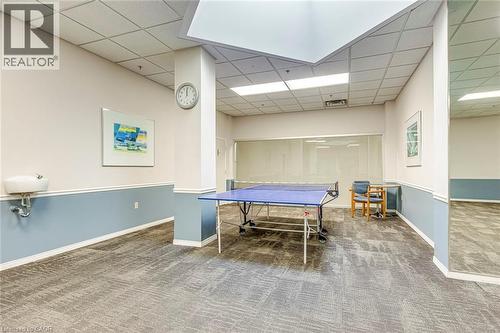 Recreational area featuring textured carpet flooring, a drop ceiling with integrated lighting, and a two-tone wall finish - 1270 Maple Crossing Boulevard Unit# 1705, Burlington, ON - Indoor Photo Showing Other Room