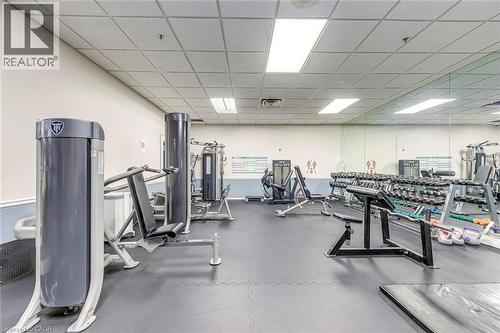 Fitness center featuring a variety of exercise equipment, mirrored wall, and recessed lighting - 1270 Maple Crossing Boulevard Unit# 1705, Burlington, ON - Indoor Photo Showing Gym Room