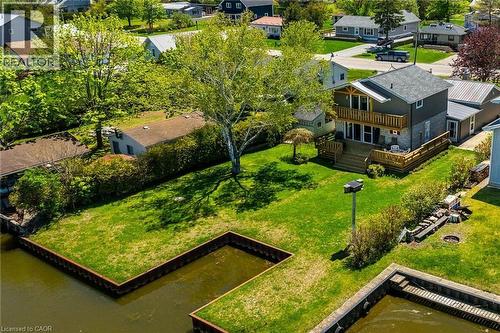 Waterfront property featuring a two-story residence with a second-level balcony and a first-level deck - 270 Erie Boulevard, Long Point, ON - Outdoor