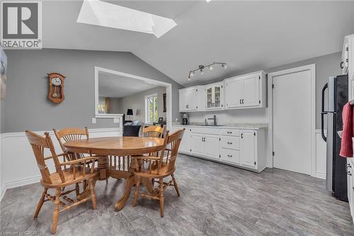 Kitchen area featuring white cabinetry, track lighting, and wood-finish flooring - 270 Erie Boulevard, Long Point, ON - Indoor Photo Showing Dining Room